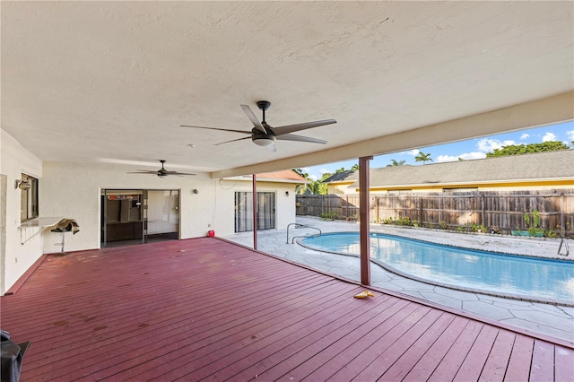 exterior space with a deck and ceiling fan