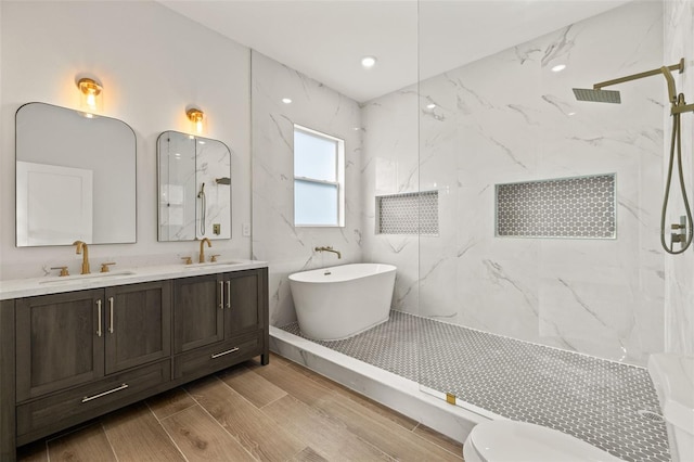 bathroom featuring vanity and shower with separate bathtub