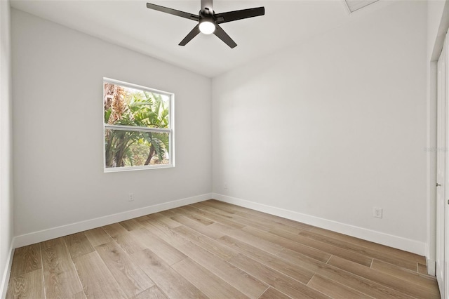 spare room with ceiling fan and light wood-type flooring