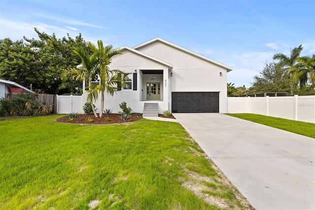 view of front of home with a garage and a front lawn