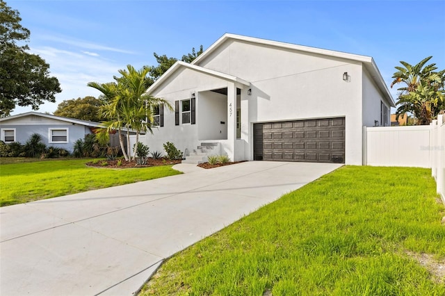 view of front of home featuring a front yard and a garage