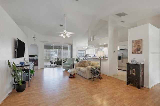 living room featuring high vaulted ceiling, ceiling fan, and light wood-type flooring