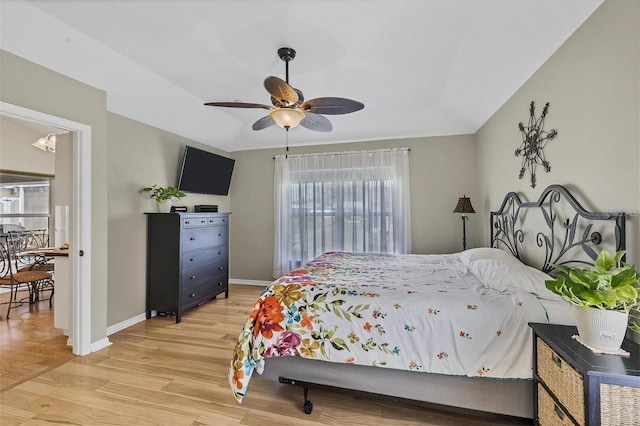 bedroom featuring ceiling fan, lofted ceiling, and light wood-type flooring