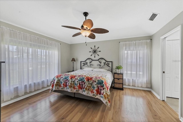 bedroom with ceiling fan and hardwood / wood-style floors