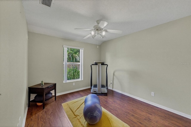 workout area with dark wood-type flooring and ceiling fan