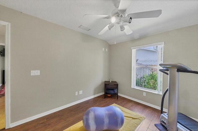 workout area with ceiling fan and hardwood / wood-style floors