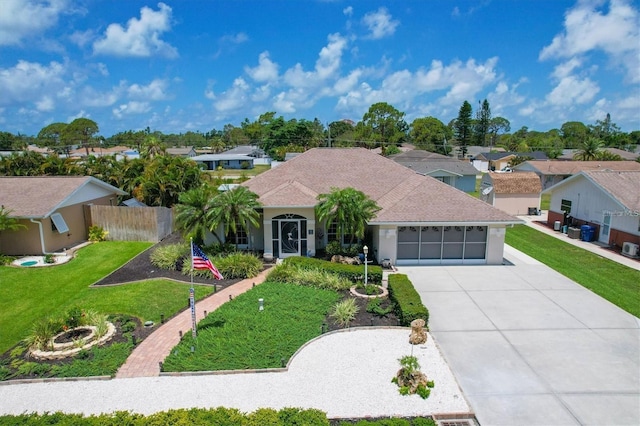 view of front of home featuring a garage and a front yard