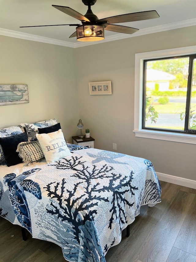 bedroom with crown molding, ceiling fan, and dark hardwood / wood-style flooring