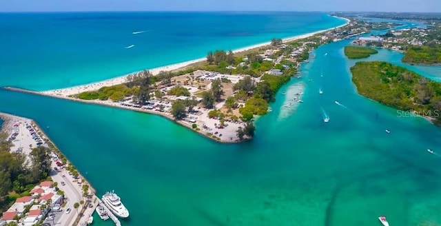 drone / aerial view featuring a water view and a beach view