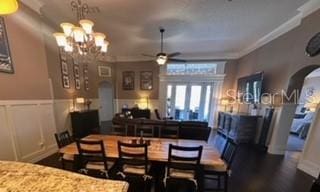 dining room featuring crown molding and ceiling fan with notable chandelier