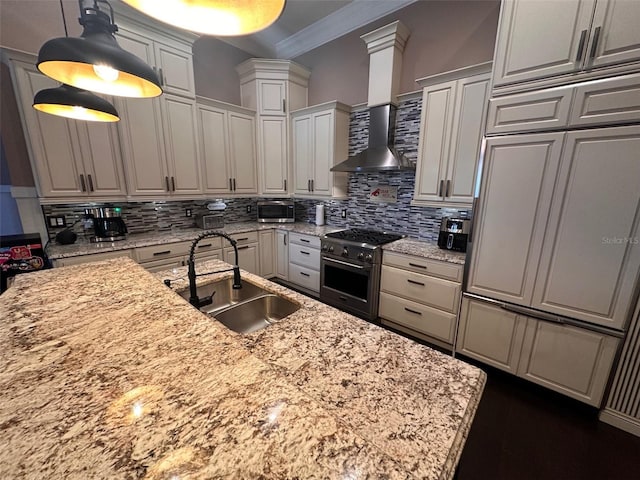 kitchen featuring decorative light fixtures, stainless steel appliances, sink, ornamental molding, and light stone counters