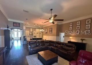 living room featuring ceiling fan, crown molding, and dark hardwood / wood-style floors