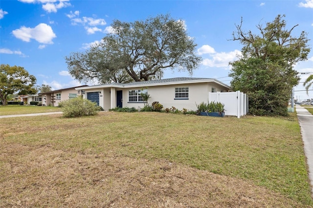 ranch-style home with a garage and a front yard