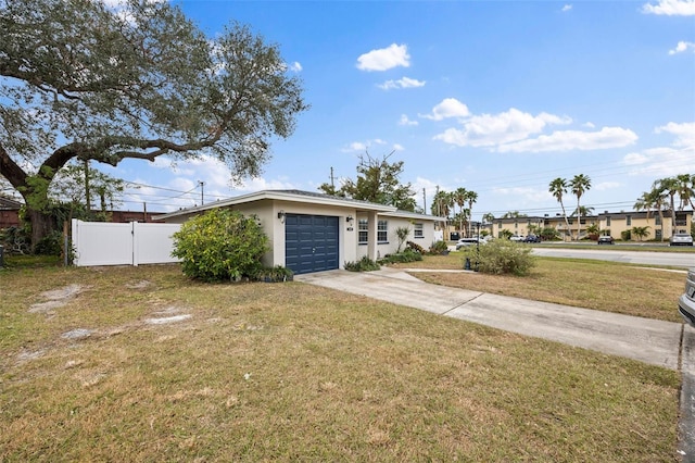 ranch-style house featuring a garage and a front lawn