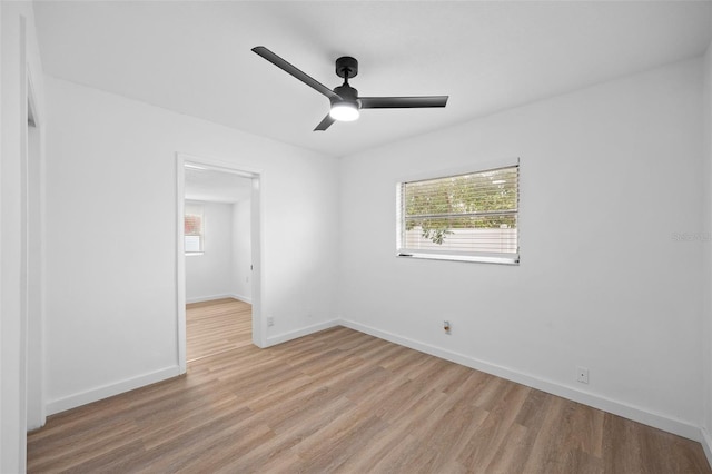 unfurnished room with light wood-type flooring and ceiling fan