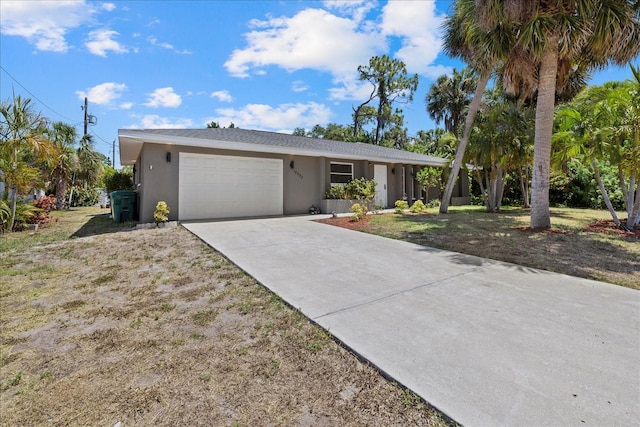 ranch-style house featuring a garage and a front lawn