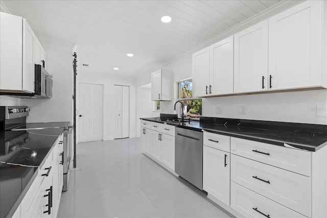 kitchen featuring white cabinets, ornamental molding, appliances with stainless steel finishes, and sink