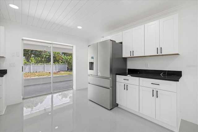 kitchen featuring stainless steel refrigerator with ice dispenser, white cabinets, and wood ceiling