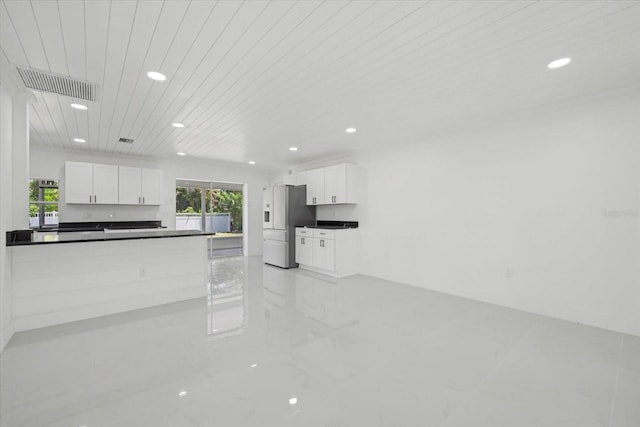 kitchen with white cabinetry and stainless steel fridge with ice dispenser