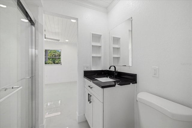 bathroom with vanity, toilet, crown molding, and a shower with door