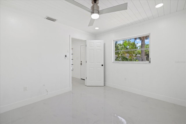 spare room featuring ceiling fan and ornamental molding