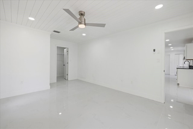 empty room with ceiling fan, sink, and wood ceiling