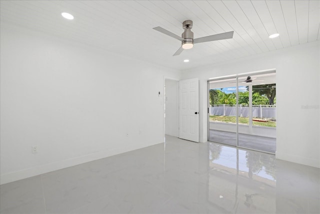 empty room featuring ceiling fan and wooden ceiling