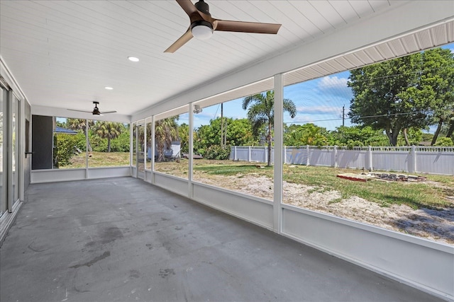 unfurnished sunroom with ceiling fan