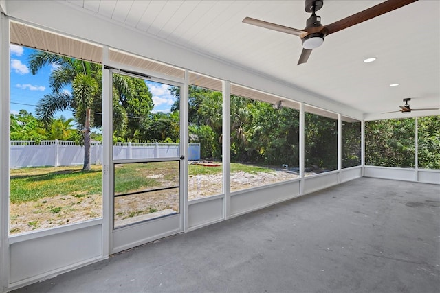 unfurnished sunroom with ceiling fan