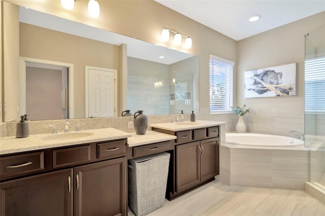 bathroom featuring independent shower and bath and vanity