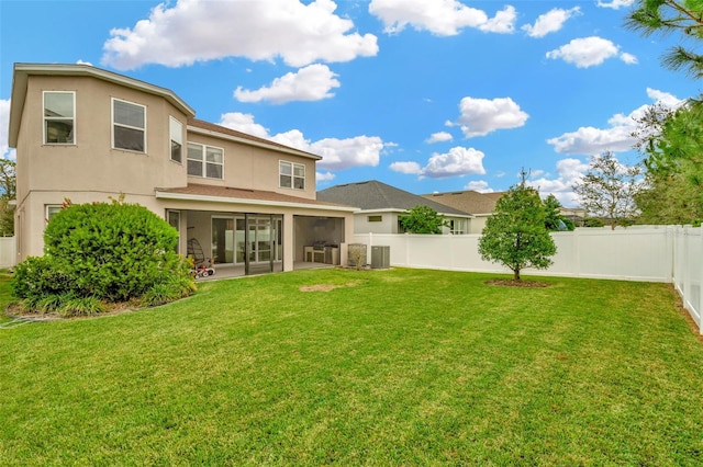 back of house featuring a patio area, central AC unit, a sunroom, and a lawn