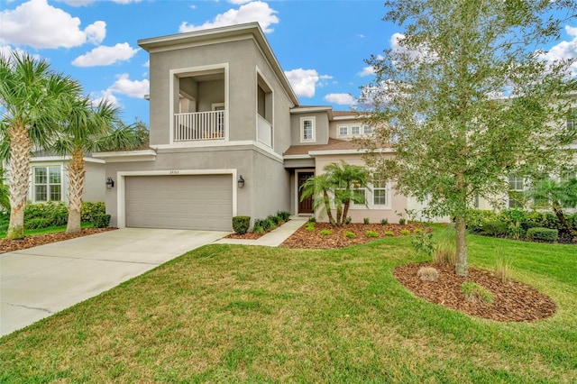 view of front of house with a balcony, a front yard, and a garage