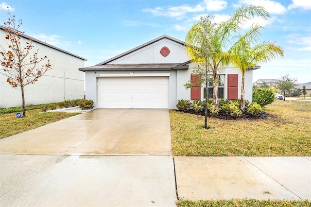 single story home featuring a garage and a front yard