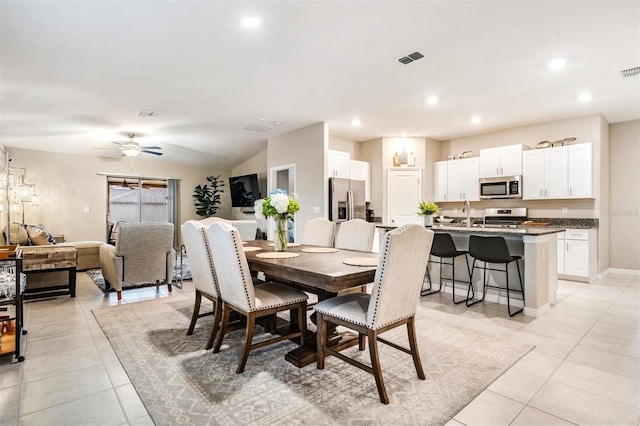 tiled dining area with ceiling fan