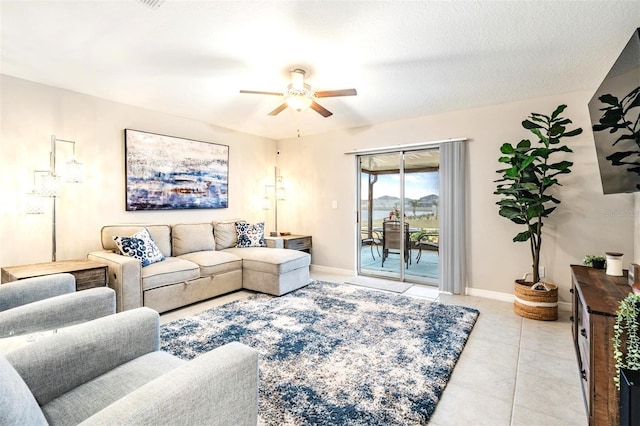 living room featuring light tile patterned floors and ceiling fan