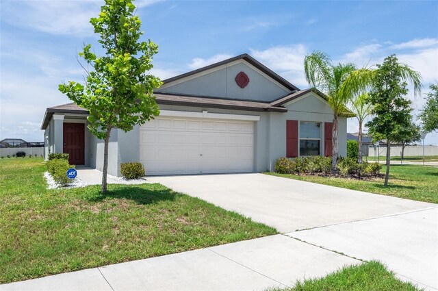 9805 Lemon Drop Loop, Sun City Center, FL 33573 - single story home with a garage, concrete driveway, a front yard, and stucco siding