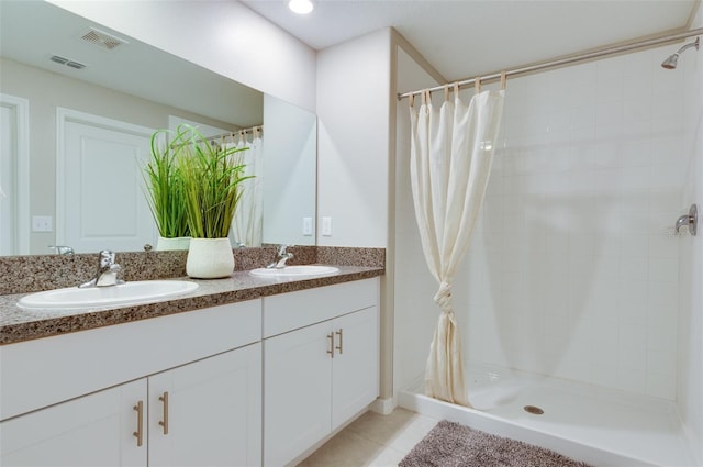 9805 Lemon Drop Loop, Sun City Center, FL 33573 - full bathroom with double vanity, a tile shower, and tile patterned floors