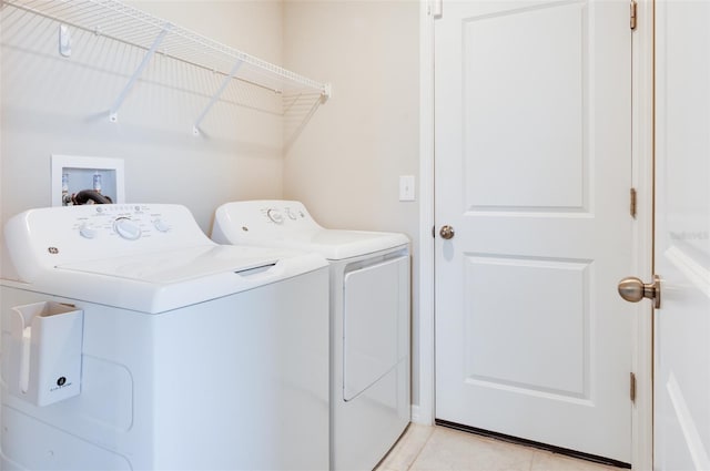 9805 Lemon Drop Loop, Sun City Center, FL 33573 - washroom featuring separate washer and dryer and light tile patterned flooring