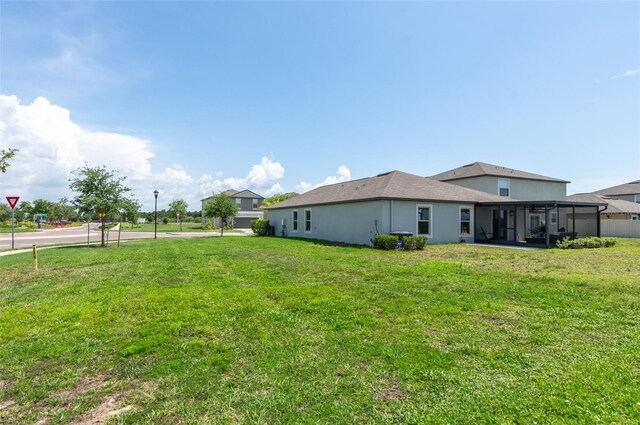 9805 Lemon Drop Loop, Sun City Center, FL 33573 - view of grassy yard featuring a sunroom