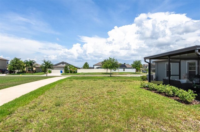 9805 Lemon Drop Loop, Sun City Center, FL 33573 - view of grassy yard with central air condition unit and a residential view