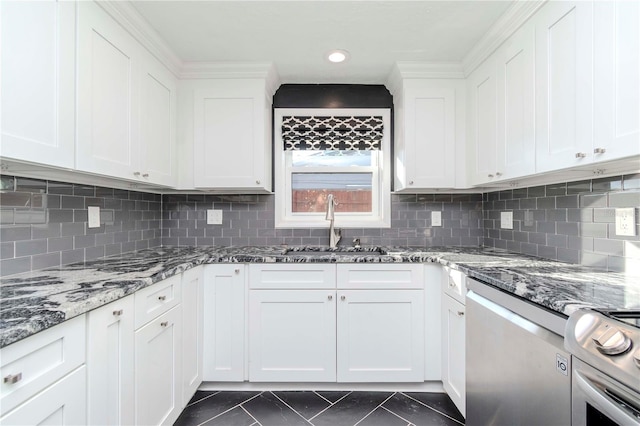 kitchen featuring white cabinets, dark stone counters, and appliances with stainless steel finishes