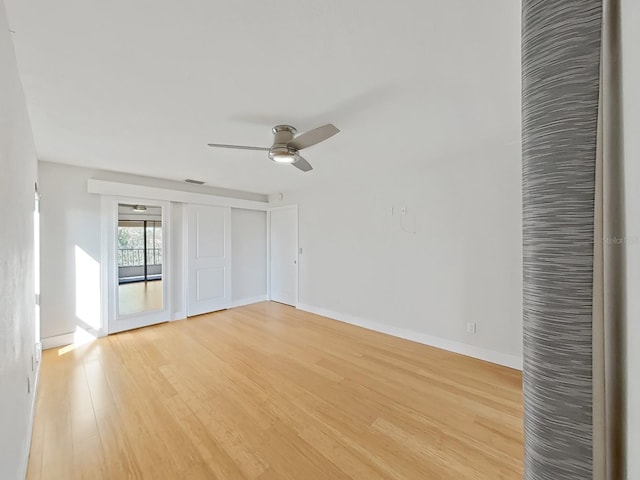 empty room featuring ceiling fan and light wood-type flooring