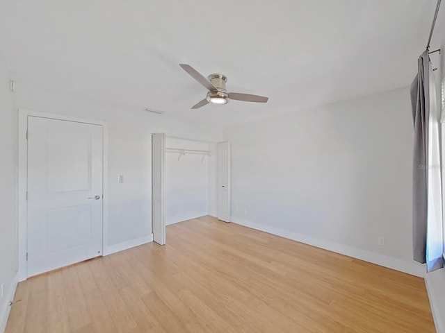 empty room featuring ceiling fan and light hardwood / wood-style floors