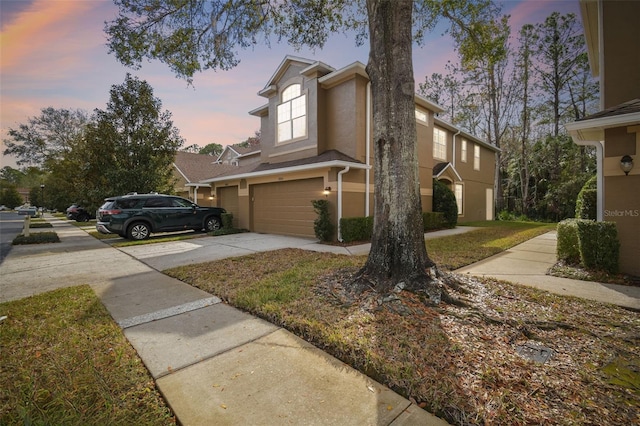 property exterior at dusk with a garage