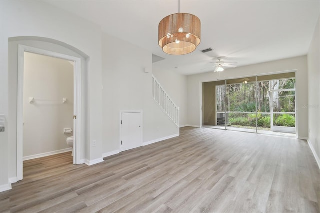 unfurnished living room featuring ceiling fan and light wood-type flooring