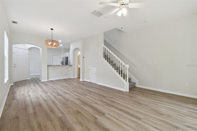 unfurnished living room with ceiling fan and light wood-type flooring