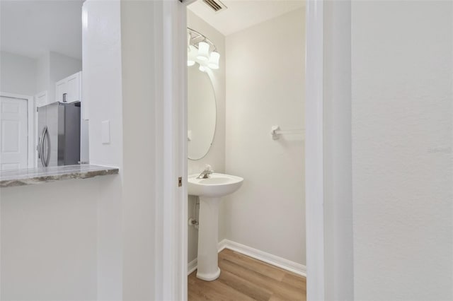 bathroom featuring sink and hardwood / wood-style flooring