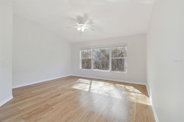 empty room with lofted ceiling, ceiling fan, and light wood-type flooring