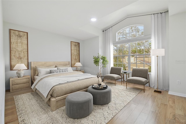 bedroom featuring lofted ceiling and light hardwood / wood-style floors