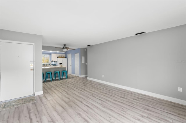 unfurnished living room with ceiling fan and light hardwood / wood-style floors